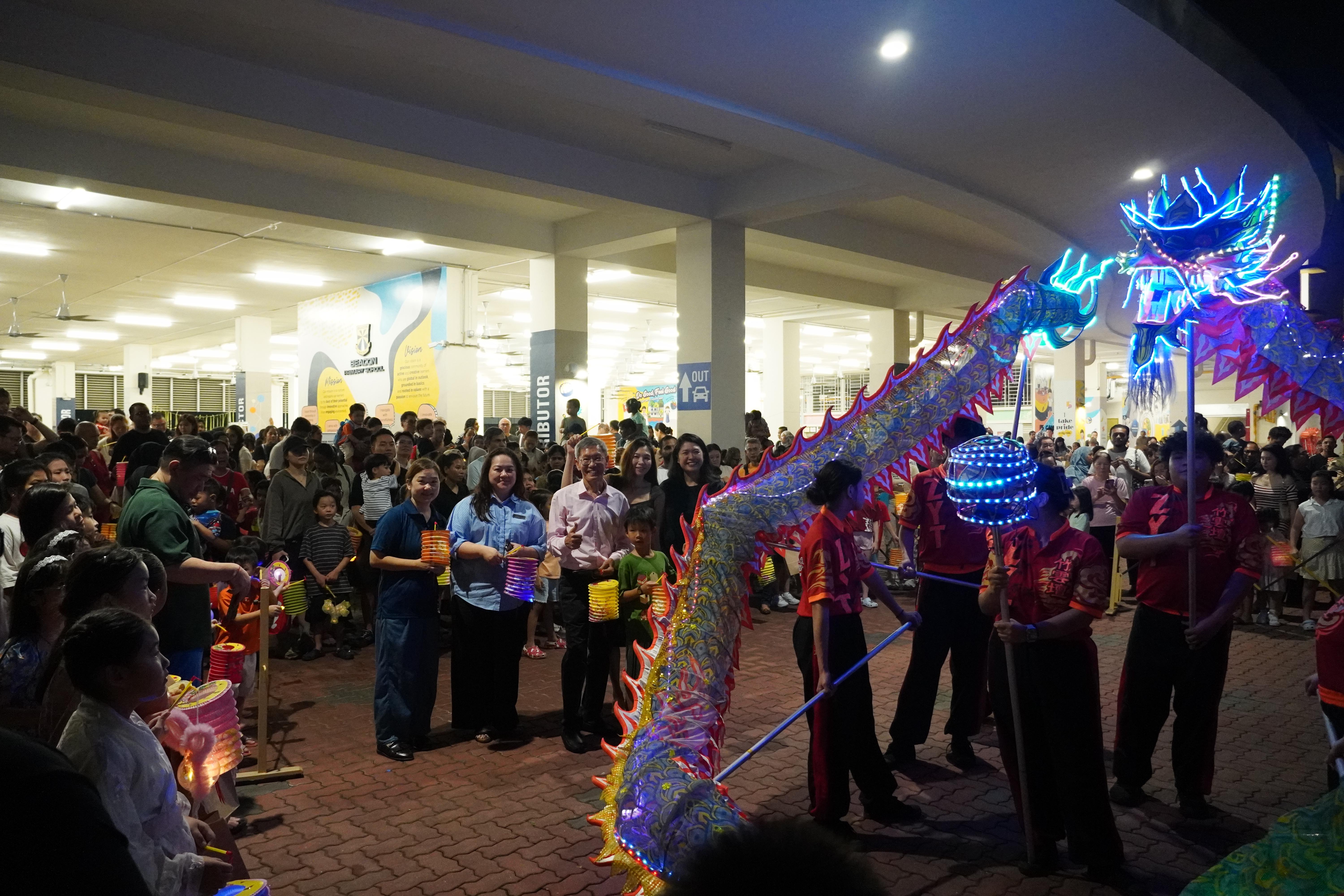 Up close with the dragon! Families and staff gathered around to enjoy the spectacular sights and energy of the glowing dragon dance.